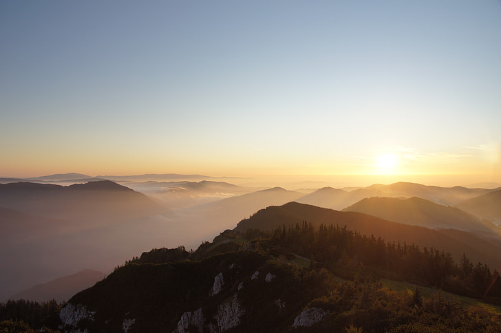 aerial view of mountain with fog during sunrise