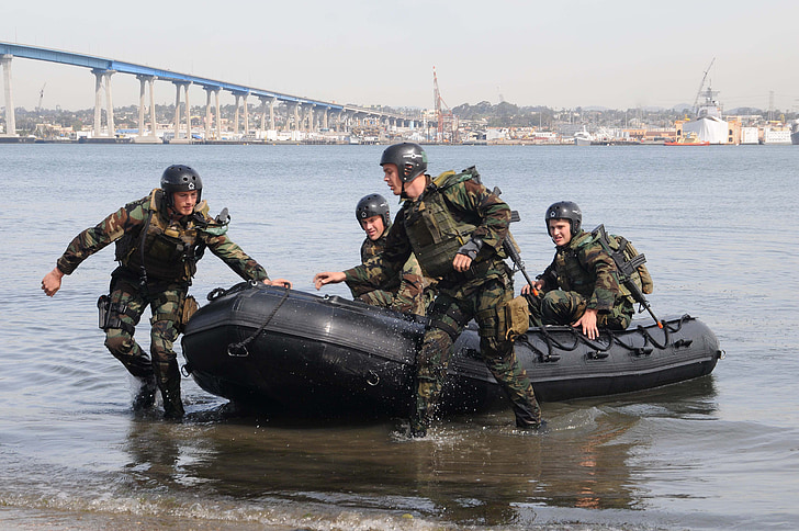 army riding inflatable boat