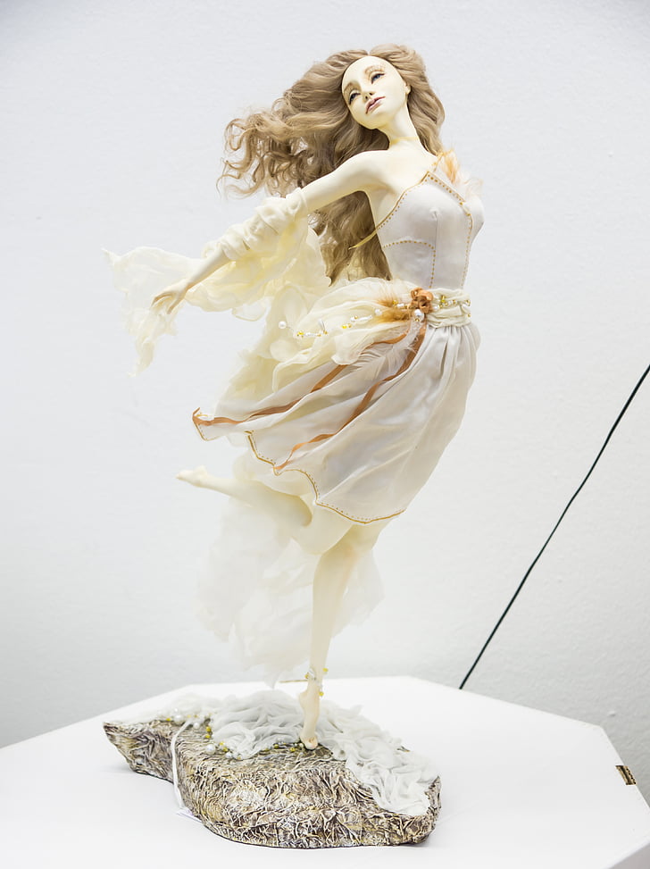 woman in gray midi dress figurine
