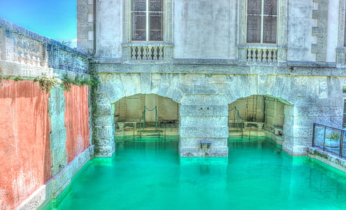 in-ground pool inside building during daytime