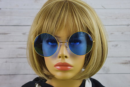 closeup photo of mannequin wearing blonde wig and sunglasses