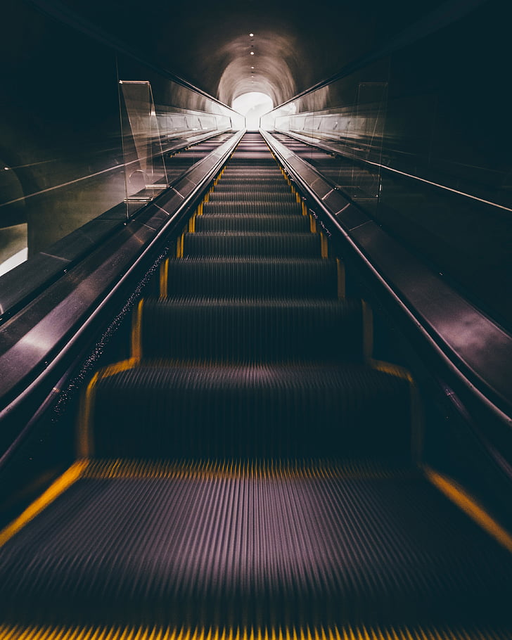 photography of underground escalator