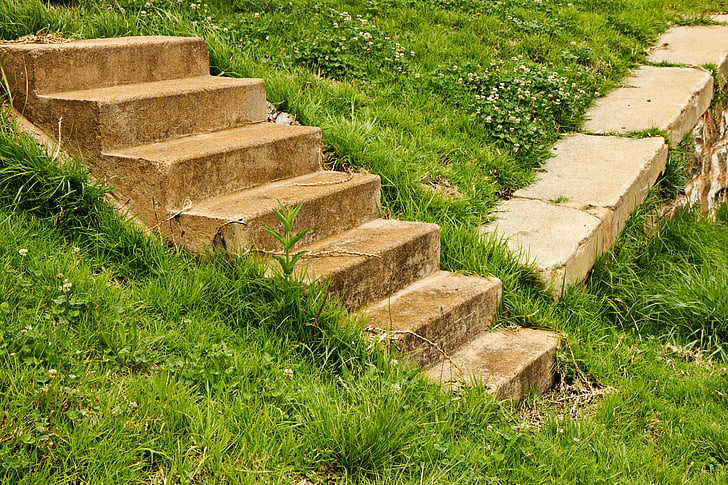 concrete stairs on green grass field