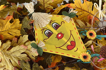 yellow and green kite on yellow leaves