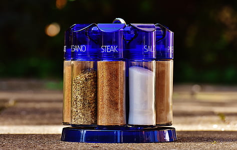 purple glass spice rack with condiments on brown surface