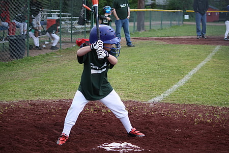 child playing baseball during daytime