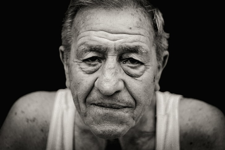 grayscale photography of man wearing tank top