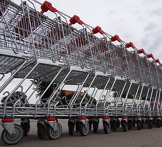photo of gray steel shopping cart lot during daytime