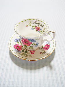 white and pink floral ceramic teacup on saucer