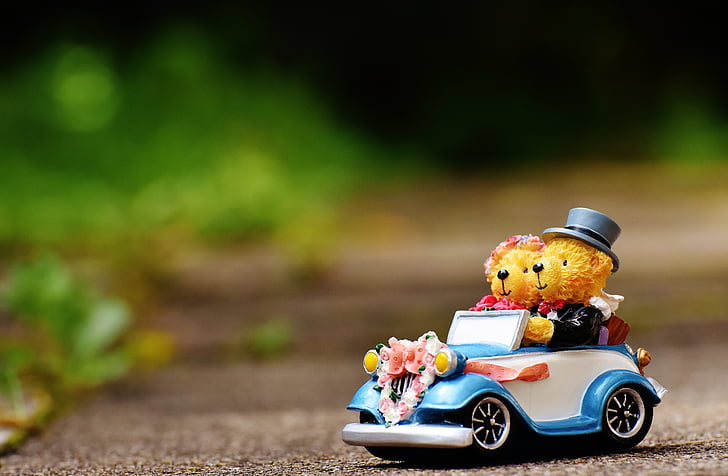 two bears riding vehicle figurine