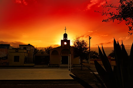 silhouette of church during sunset