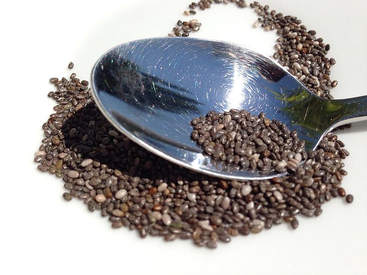 silver metal spoon with black grains