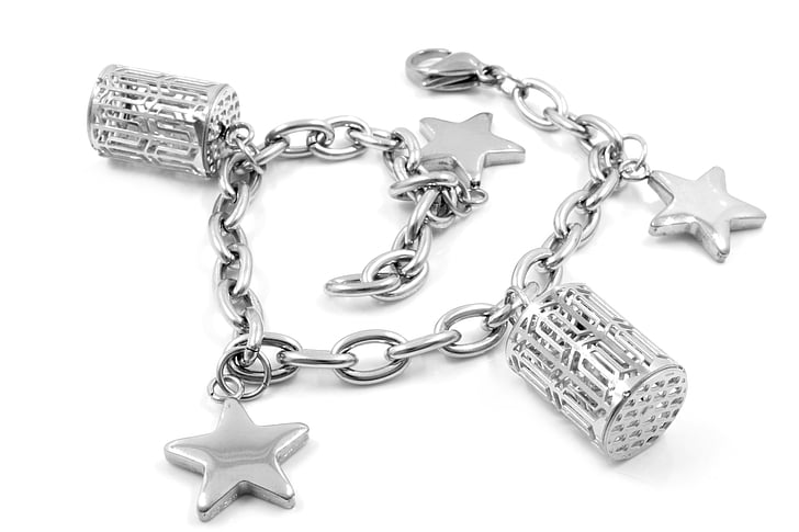 silver-colored charm bracelet on white surface