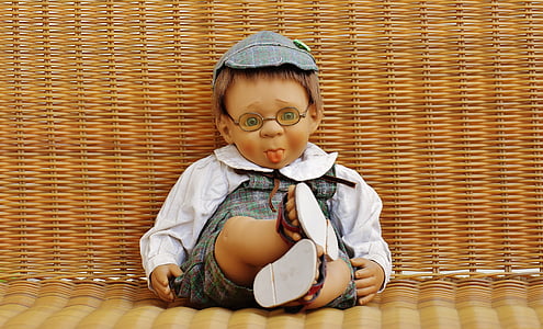 boy wearing white and gray top doll