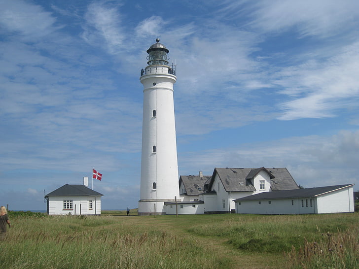 white lighthouse and grass field