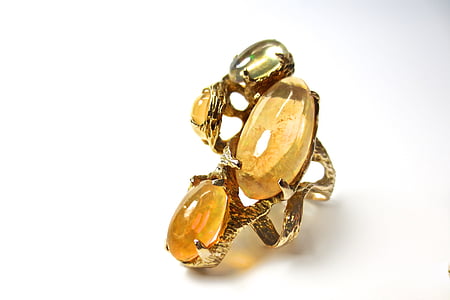 gold-colored ring with brown gemstones