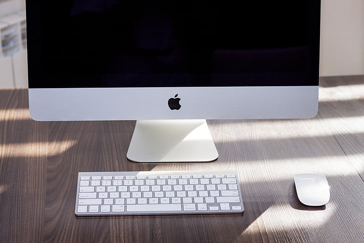 silver iMac near Apple Wireless Keyboard and Apple Magic Mouse