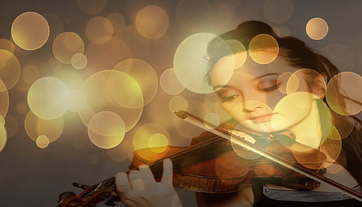 bokeh photography of woman playing violin