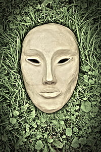 brown concrete mask on green grass