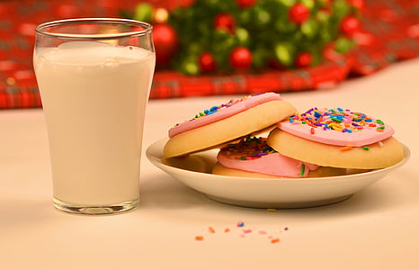 milk beside cookies on white plate
