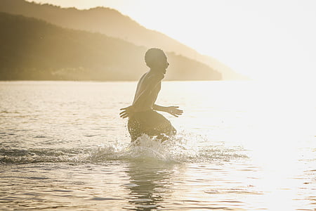 boy running on water during golden time