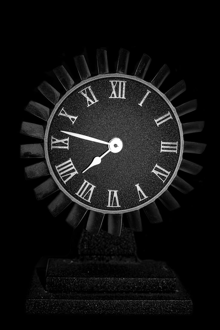 black and white analog clock reading at 7:47