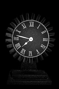 black and white analog clock reading at 7:47