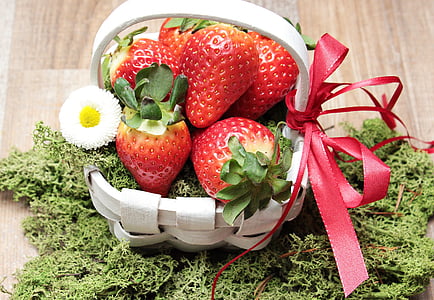 strawberry fruits on white woven basket