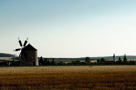 white and brown windmill during daytime