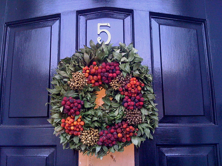 closed door with flower wreath hanged on it
