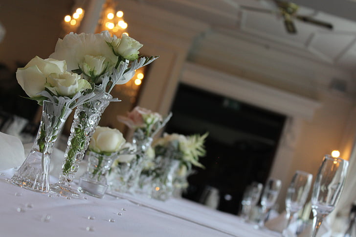 white roses centerpieces with lighted candles