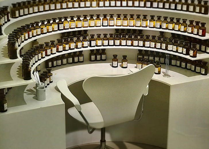 chair surrounded by bottles on table