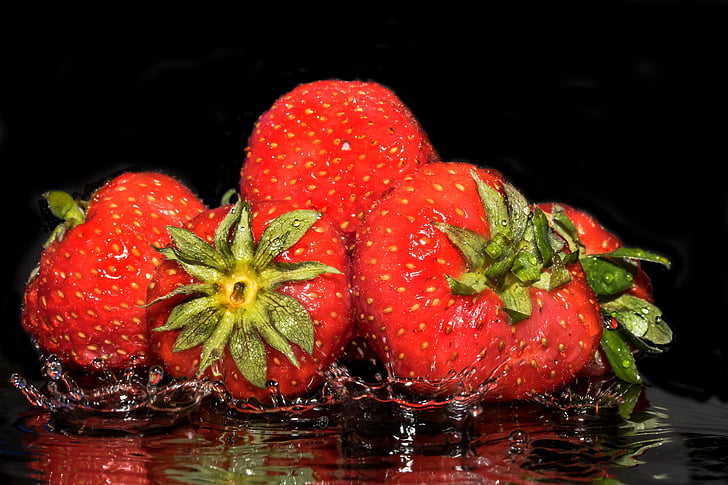 strawberries splashing on water