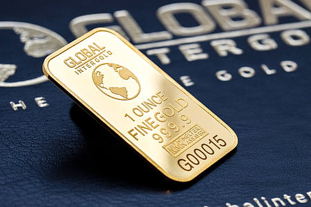 rectangular gold Global Intergold 1 ounce fine gold on blue surface