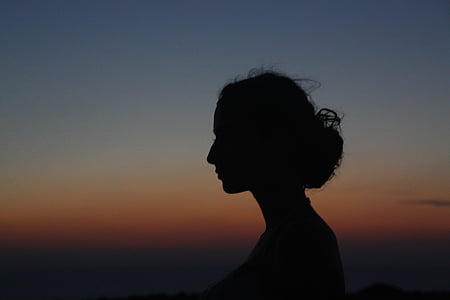 silhouette photo of person's face during nighttime