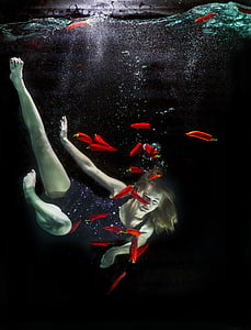 woman under body of water with chili pepper