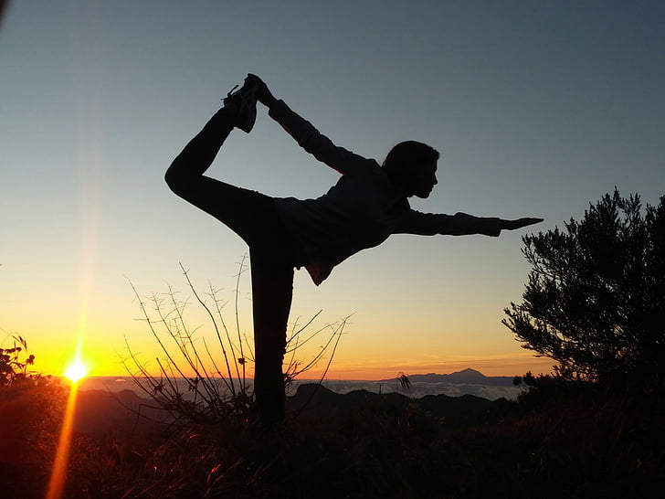 silhouette photo of person doing yoga position