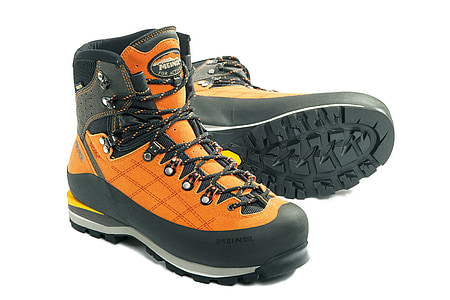 pair of orange hiking boots against white background