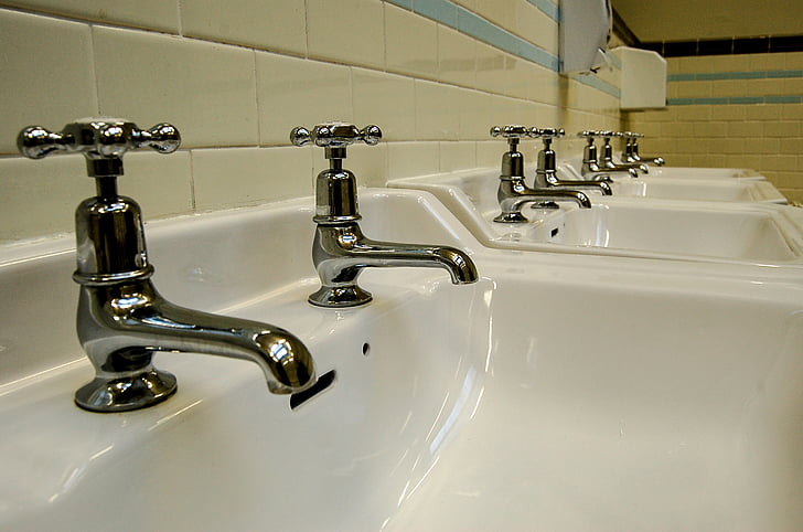 lined gray white sinks with gray faucets