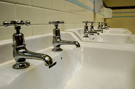 lined gray white sinks with gray faucets