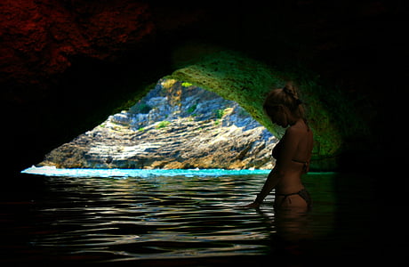 woman on beach cave