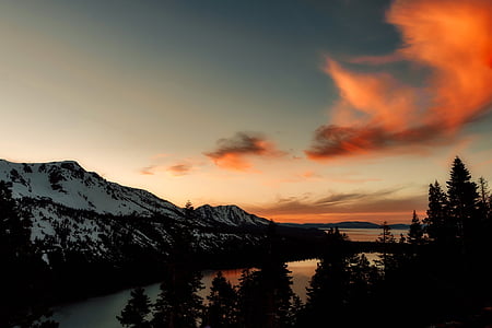 silhouette photo of mountains, sky, and body of water