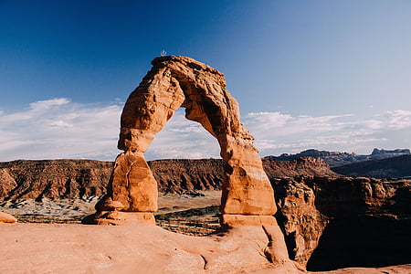 brown stone arch across canyons