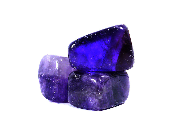 three purple gemstones