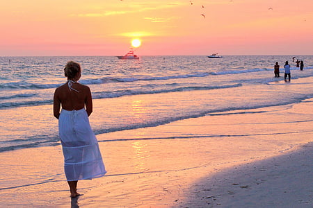 woman standing beside seashore
