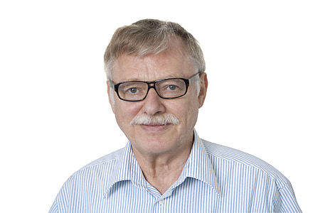 portrait photo of man wearing eyeglasses and stripe top