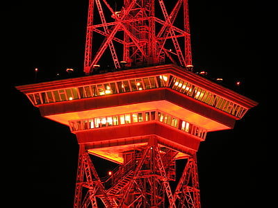 orange metal tower during nighttime
