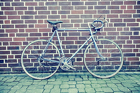gray bike behind brown wall