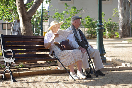 old man and woman on wooden bench