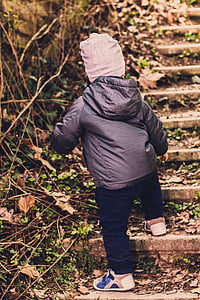 toddler walking on concrete stairs outdoors